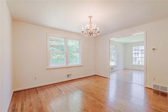21 Chipping, Perinton, NY 14450 - empty room featuring a chandelier and light wood-style flooring