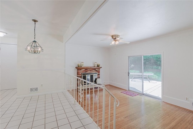 21 Chipping, Perinton, NY 14450 - spare room with ceiling fan, a brick fireplace, light wood finished floors, ornamental molding, and a chandelier