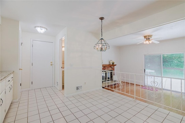 21 Chipping, Perinton, NY 14450 - kitchen with white cabinets, a ceiling fan, light countertops, light tile patterned flooring, and decorative light fixtures