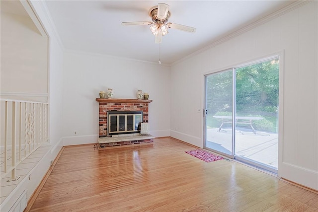 21 Chipping, Perinton, NY 14450 - unfurnished living room featuring wood finished floors, ornamental molding, a ceiling fan, and a brick fireplace