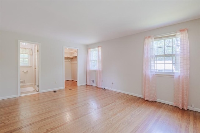 21 Chipping, Perinton, NY 14450 - unfurnished bedroom with light wood finished floors, ensuite bath, and a walk in closet