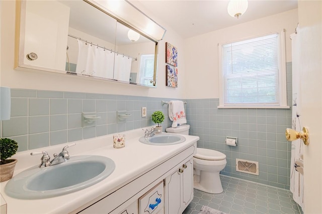 21 Chipping, Perinton, NY 14450 - full bathroom with tile walls, double vanity, wainscoting, and curtained shower