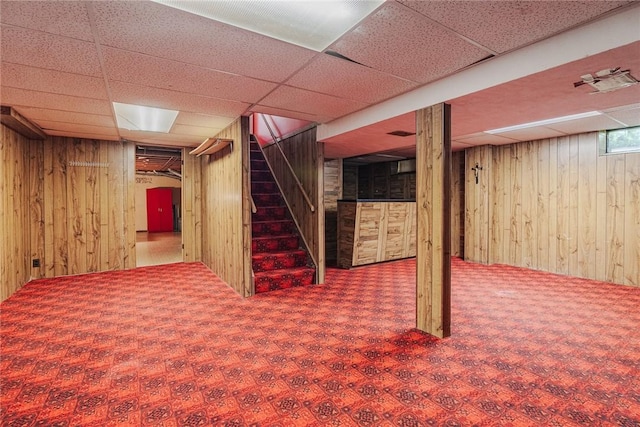 21 Chipping, Perinton, NY 14450 - below grade area featuring wood walls, stairway, carpet floors, and a drop ceiling