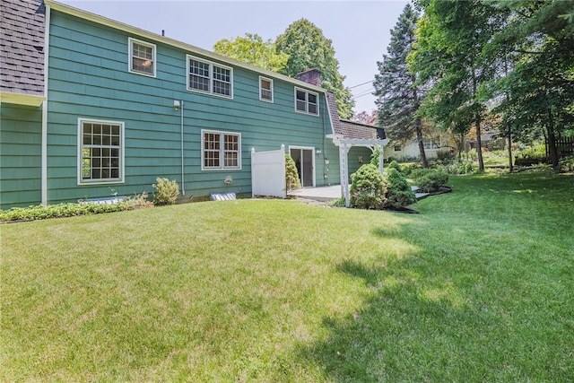 21 Chipping, Perinton, NY 14450 - rear view of house with a chimney and a yard