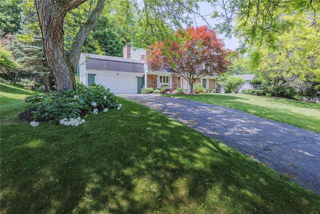 21 Chipping, Perinton, NY 14450 - view of front of house featuring a chimney, a garage, driveway, and a front lawn