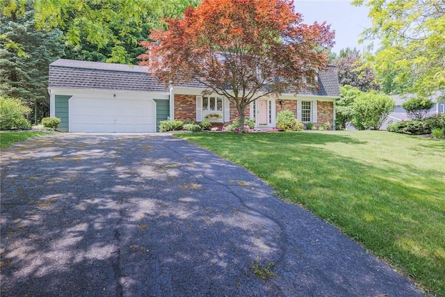 21 Chipping, Perinton, NY 14450 - view of front of home featuring asphalt driveway, a front yard, an attached garage, a shingled roof, and brick siding
