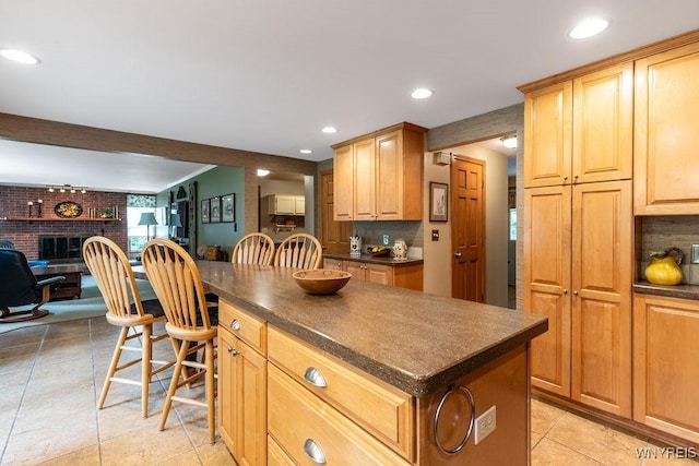 11544 Howe Rd, Newstead, NY 14001 - kitchen featuring dark countertops, a kitchen island, tasteful backsplash, a fireplace, and recessed lighting