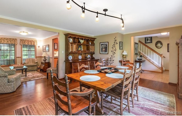11544 Howe Rd, Newstead, NY 14001 - dining room featuring stairway, hardwood / wood-style flooring, and ornamental molding