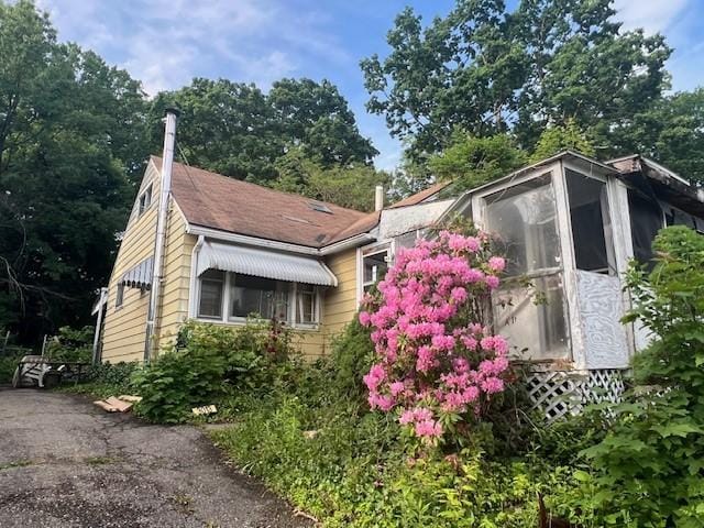 3013 Robins St, Union, NY 13760 - view of side of home with a chimney and a sunroom