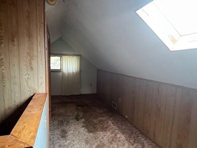 3013 Robins St, Union, NY 13760 - bonus room featuring a skylight, wooden walls, vaulted ceiling, and carpet floors
