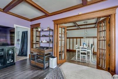 302 N James St, Wilna, NY 13619 - office space featuring french doors, coffered ceiling, wood finished floors, and beamed ceiling