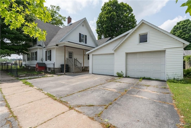 302 N James St, Wilna, NY 13619 - traditional home with a detached garage, a chimney, an outdoor structure, and a shingled roof