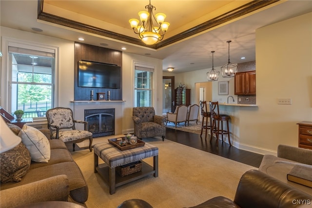 3389 Long Shadow Dr, Lysander, NY 13027 - living room with a raised ceiling, a chandelier, wood finished floors, a fireplace, and recessed lighting