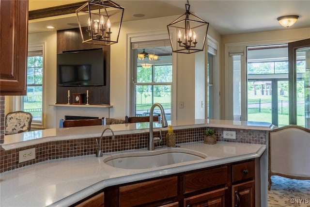 3389 Long Shadow Dr, Lysander, NY 13027 - kitchen with a chandelier, healthy amount of natural light, and light countertops