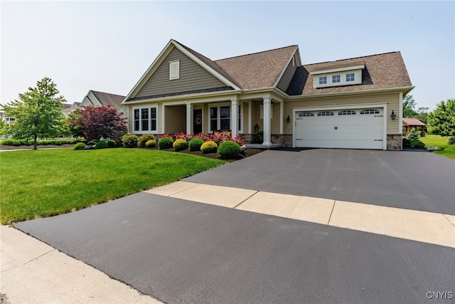 3389 Long Shadow Dr, Lysander, NY 13027 - craftsman-style house with covered porch, a front lawn, asphalt driveway, stone siding, and a garage