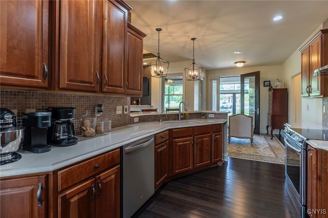 3389 Long Shadow Dr, Lysander, NY 13027 - kitchen featuring stainless steel appliances, dark wood-style flooring, a peninsula, light countertops, and tasteful backsplash