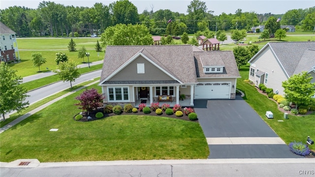 3389 Long Shadow Dr, Lysander, NY 13027 - view of front of house with asphalt driveway, a front lawn, a porch, and an attached garage