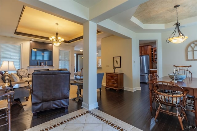 3389 Long Shadow Dr, Lysander, NY 13027 - dining area featuring a raised ceiling, a chandelier, and wood finished floors