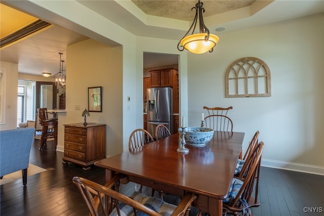 3389 Long Shadow Dr, Lysander, NY 13027 - dining area featuring a raised ceiling and dark wood-type flooring