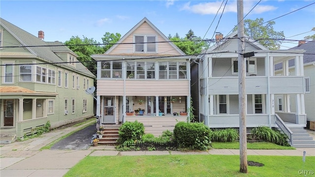 314 Apple St, Syracuse, NY 13204 - view of front of house featuring covered porch, driveway, and a front lawn