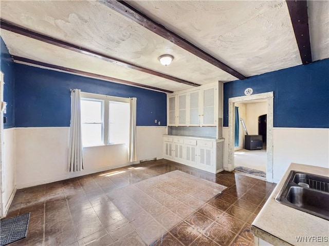 69 Halstead Ave, Cheektowaga, NY 14212 - spare room with beamed ceiling and wainscoting