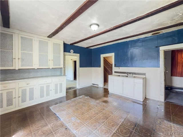 69 Halstead Ave, Cheektowaga, NY 14212 - kitchen with light countertops, white cabinets, glass insert cabinets, and beam ceiling
