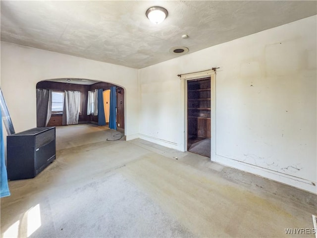 69 Halstead Ave, Cheektowaga, NY 14212 - carpeted empty room with arched walkways and baseboards