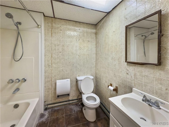 69 Halstead Ave, Cheektowaga, NY 14212 - bathroom with shower / bathtub combination, vanity, and tile walls
