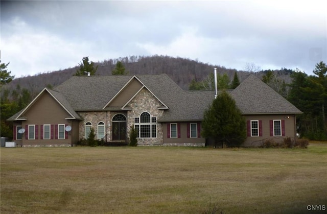 11668 State Route 30, Malone, NY 12953 - traditional home with a front lawn, stone siding, a mountain view, and roof with shingles