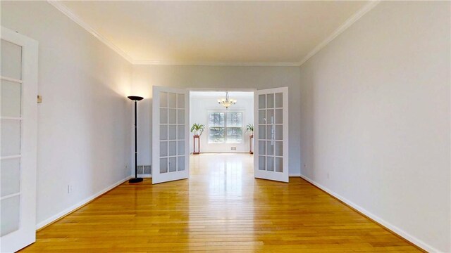 106 Woodsview, Erwin, NY 14870 - spare room featuring french doors, light wood finished floors, a chandelier, and crown molding