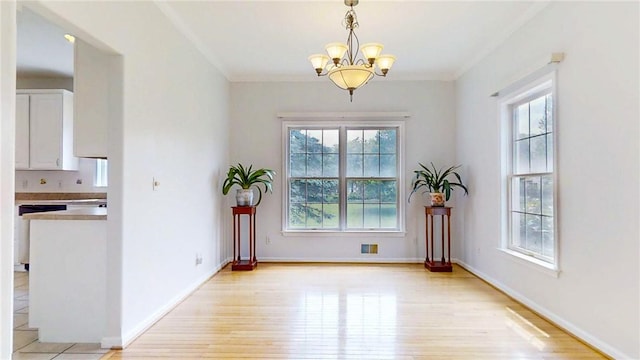 106 Woodsview, Erwin, NY 14870 - unfurnished dining area featuring healthy amount of natural light, light wood-style flooring, a chandelier, and ornamental molding