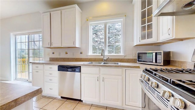 106 Woodsview, Erwin, NY 14870 - kitchen with stainless steel appliances, under cabinet range hood, white cabinets, glass insert cabinets, and light countertops