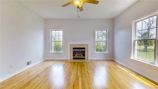 106 Woodsview, Erwin, NY 14870 - unfurnished living room featuring healthy amount of natural light, light wood-style floors, and a high end fireplace
