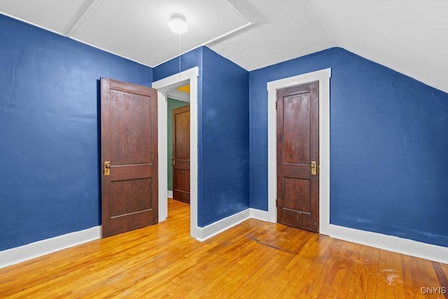 500 Glenwood Ave, Syracuse, NY 13207 - unfurnished bedroom with hardwood / wood-style flooring and lofted ceiling