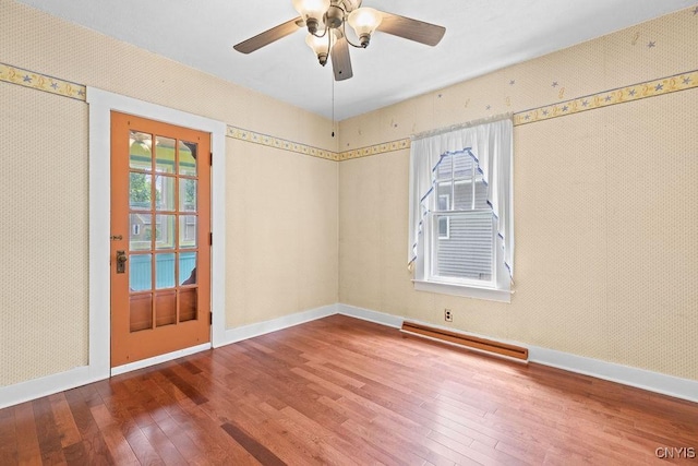 500 Glenwood Ave, Syracuse, NY 13207 - empty room with a baseboard radiator, wood-type flooring, and a ceiling fan