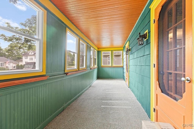 500 Glenwood Ave, Syracuse, NY 13207 - unfurnished sunroom with healthy amount of natural light, carpet flooring, and wood walls