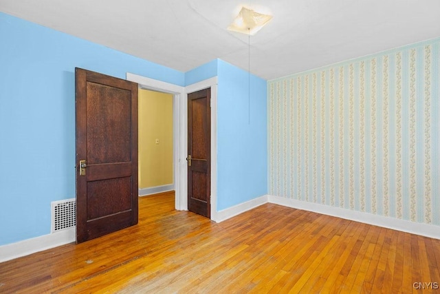 500 Glenwood Ave, Syracuse, NY 13207 - spare room featuring light wood-style flooring and wallpapered walls