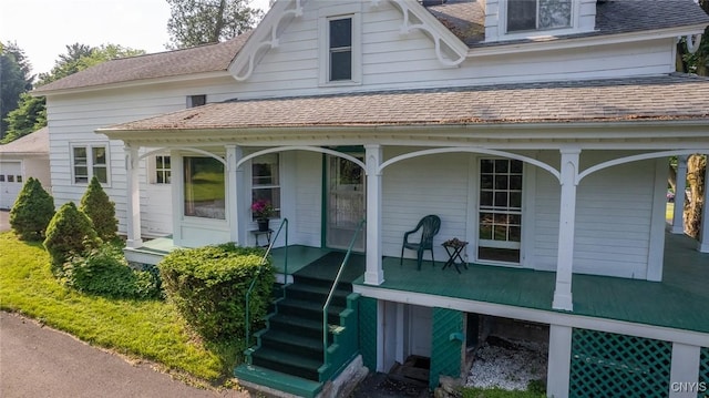 810 Franklin St, Skaneateles, NY 13152 - view of front of home with a porch, a shingled roof, and a garage