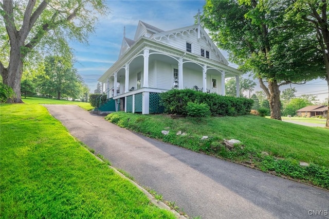810 Franklin St, Skaneateles, NY 13152 - view of side of home with covered porch, a lawn, and asphalt driveway