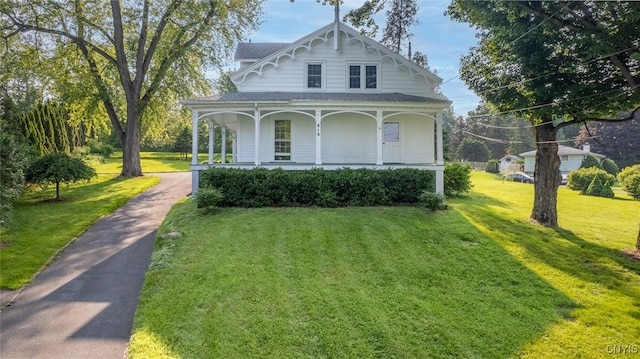 810 Franklin St, Skaneateles, NY 13152 - victorian-style house with covered porch, a front lawn, and a shingled roof