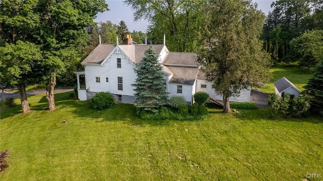 810 Franklin St, Skaneateles, NY 13152 - view of side of property featuring a lawn, a chimney, and roof with shingles