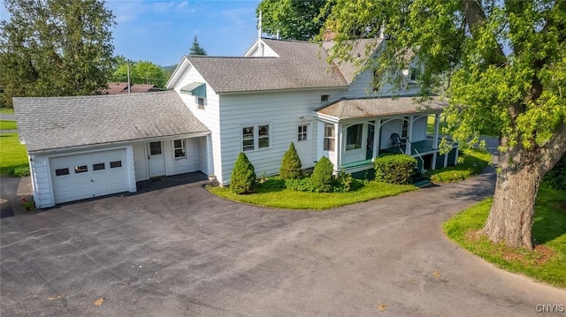 810 Franklin St, Skaneateles, NY 13152 - view of front of property with driveway, a garage, roof with shingles, covered porch, and a chimney