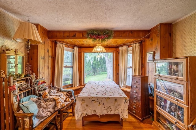 810 Franklin St, Skaneateles, NY 13152 - living area with wallpapered walls, wood finished floors, a textured ceiling, and crown molding