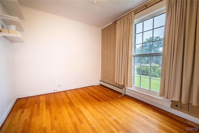 810 Franklin St, Skaneateles, NY 13152 - empty room featuring a baseboard heating unit and light wood finished floors