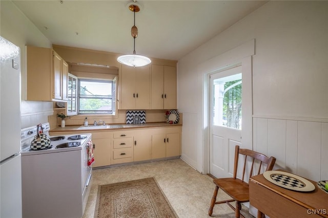 810 Franklin St, Skaneateles, NY 13152 - kitchen with white appliances, decorative light fixtures, wainscoting, light countertops, and cream cabinetry