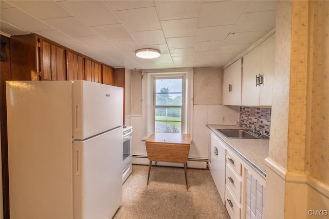 810 Franklin St, Skaneateles, NY 13152 - kitchen with freestanding refrigerator, stove, light countertops, white cabinets, and a baseboard radiator