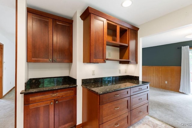 4581 Nelson Rd, Fenner, NY 13035 - kitchen with open shelves, light carpet, dark stone counters, wainscoting, and wooden walls