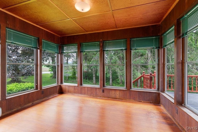 4581 Nelson Rd, Fenner, NY 13035 - unfurnished sunroom featuring wood walls and wood finished floors