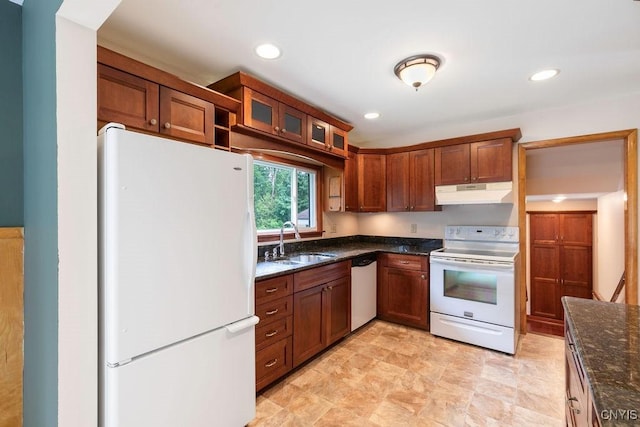 4581 Nelson Rd, Fenner, NY 13035 - kitchen with white appliances, under cabinet range hood, dark stone counters, glass insert cabinets, and brown cabinets