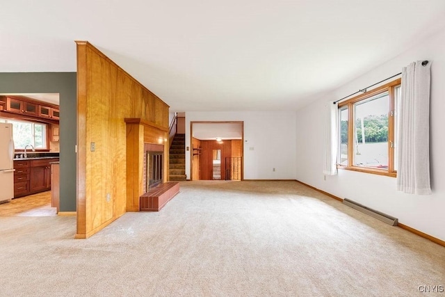 4581 Nelson Rd, Fenner, NY 13035 - unfurnished living room featuring baseboard heating, light colored carpet, and stairway
